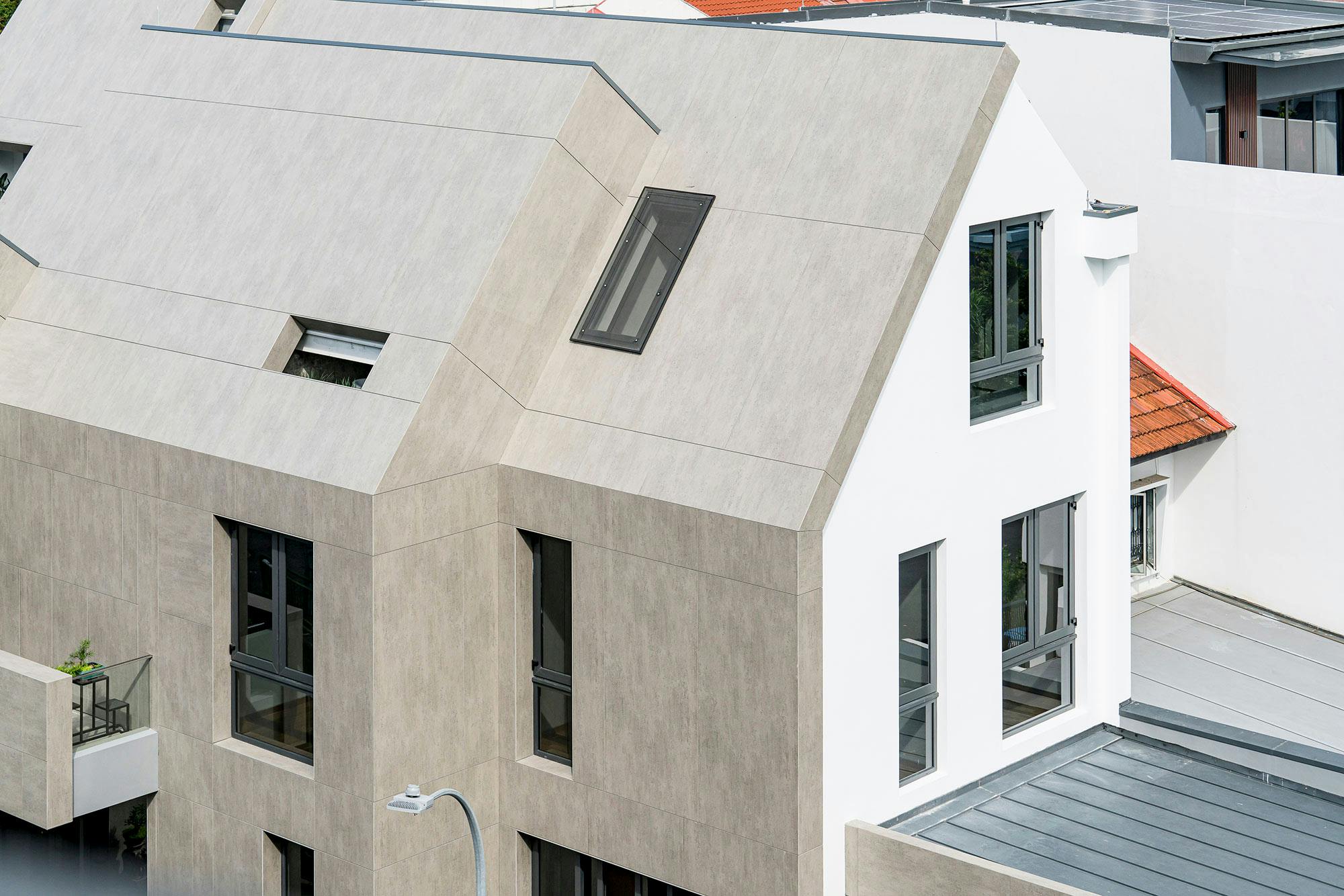 Image number 35 of the current section of Only two façade elements (recessed windows and slanted Dekton panels) create variety  in Cosentino Ireland