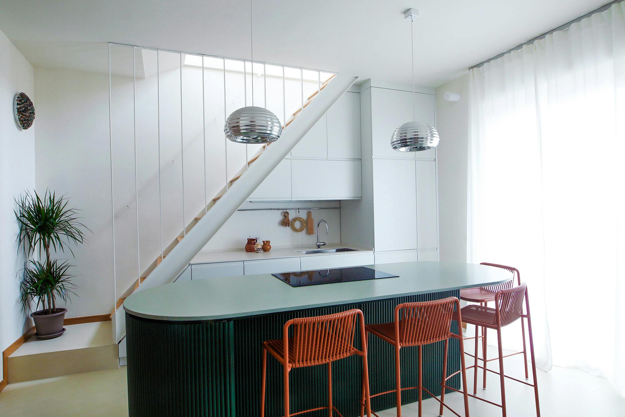 Image of Flatwig Studio Rooftop House in Milan 5.jpg?auto=format%2Ccompress&ixlib=php 3.3 in A functional kitchen under the stairs to make the most of space without compromising on design - Cosentino