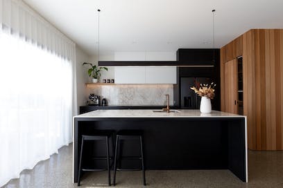 A Contemporary Black Kitchen Features Dekton Bergen