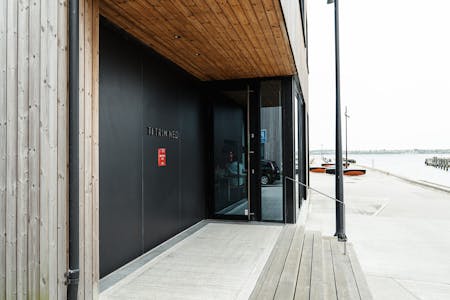Image of Ti Trin Ned New Entrance 1 2.jpg?auto=format%2Ccompress&fit=crop&ixlib=php 3.3 in This Michelin-starred Danish restaurant uses Dekton on its façade to withstand the harsh marine environment  - Cosentino