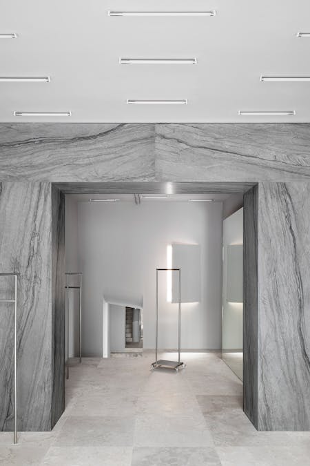 Image of Redondo Brand Store GERMAN SAIZ 3.jpg?auto=format%2Ccompress&fit=crop&ixlib=php 3.3 in A monolithic arch in Sensa Platino gives character to a new fashion shop in Madrid - Cosentino